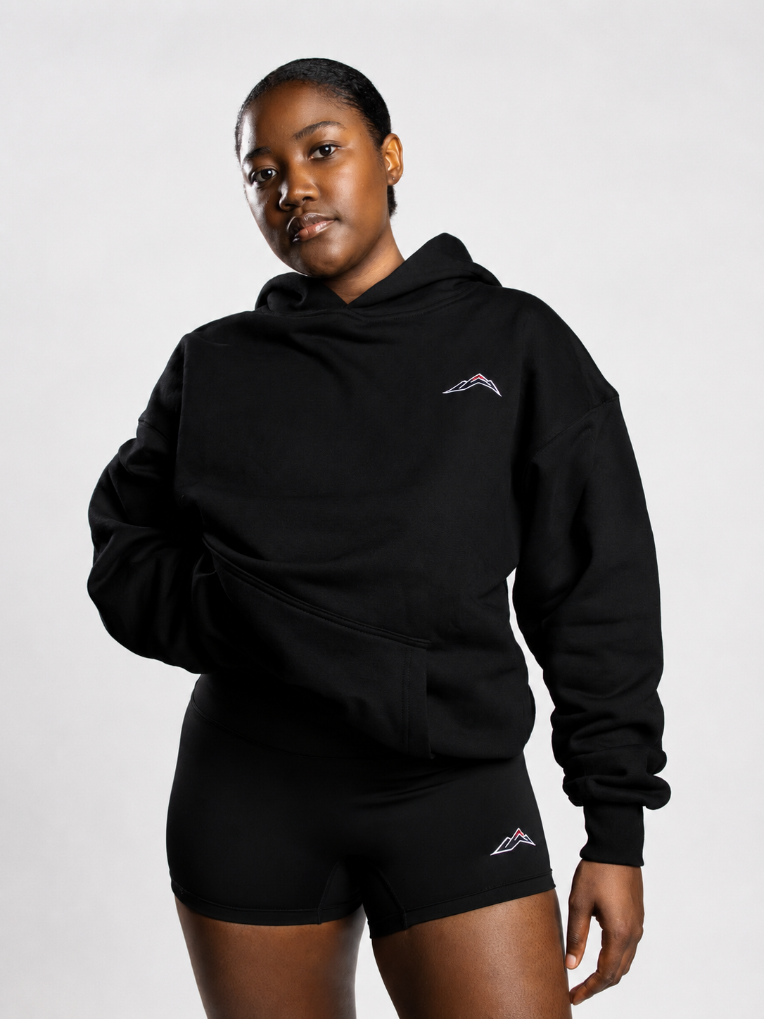 MÒN The Summit Hoodie paired with logo shorts, front lifestyle view