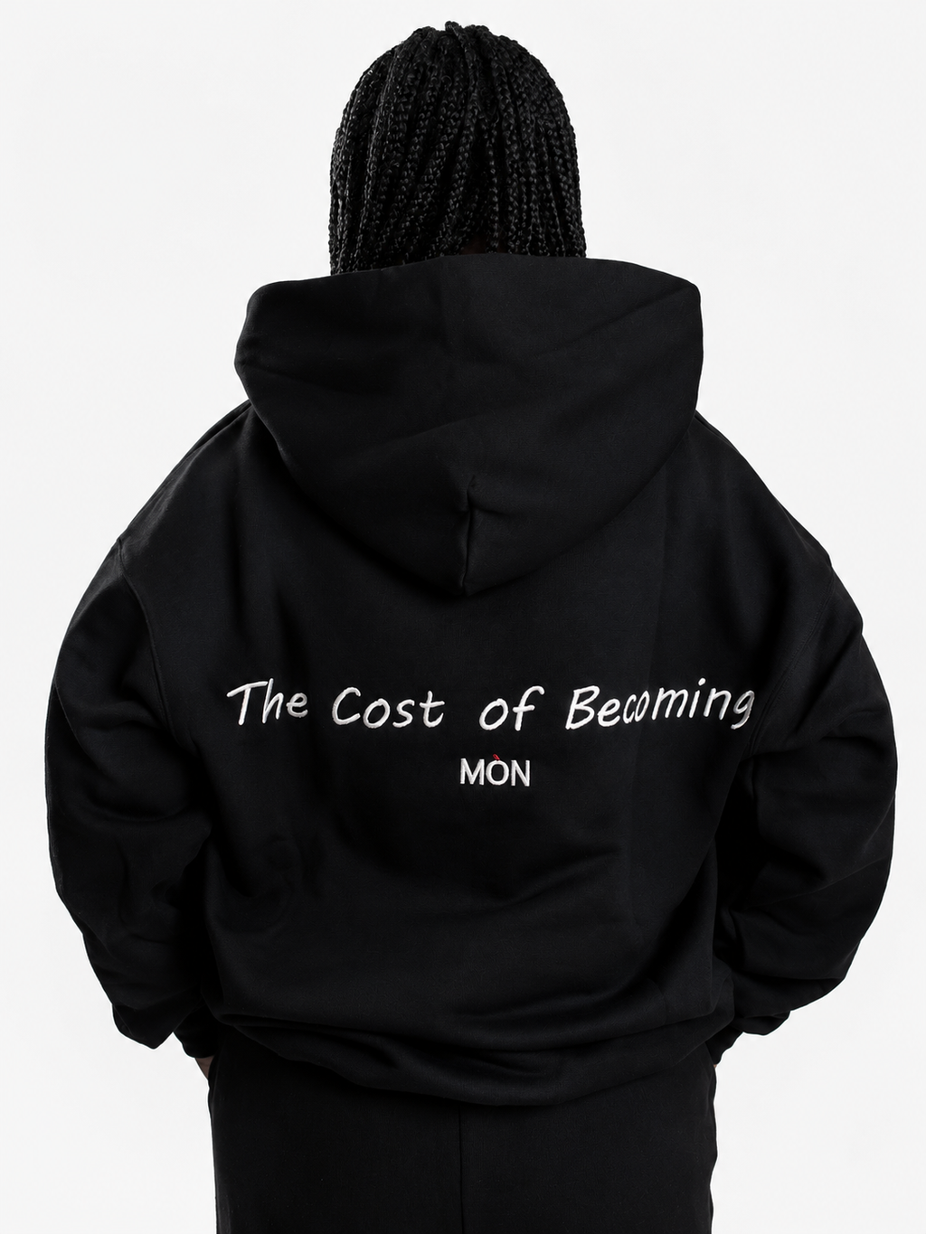 MÒN The Summit Hoodie in black, back view with "The Cost of Becoming" embroidery detail