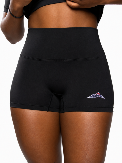 MÒN The Core Shorts in black, close-up of high-rise waistband with embroidered mountain logo