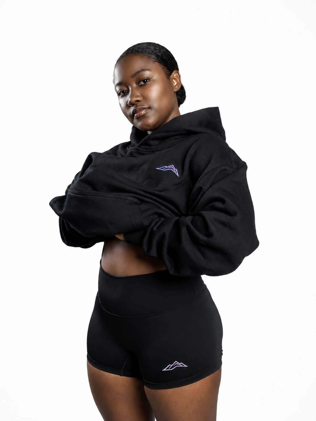 MÒN The Core Shorts in black, styled with a cropped hoodie