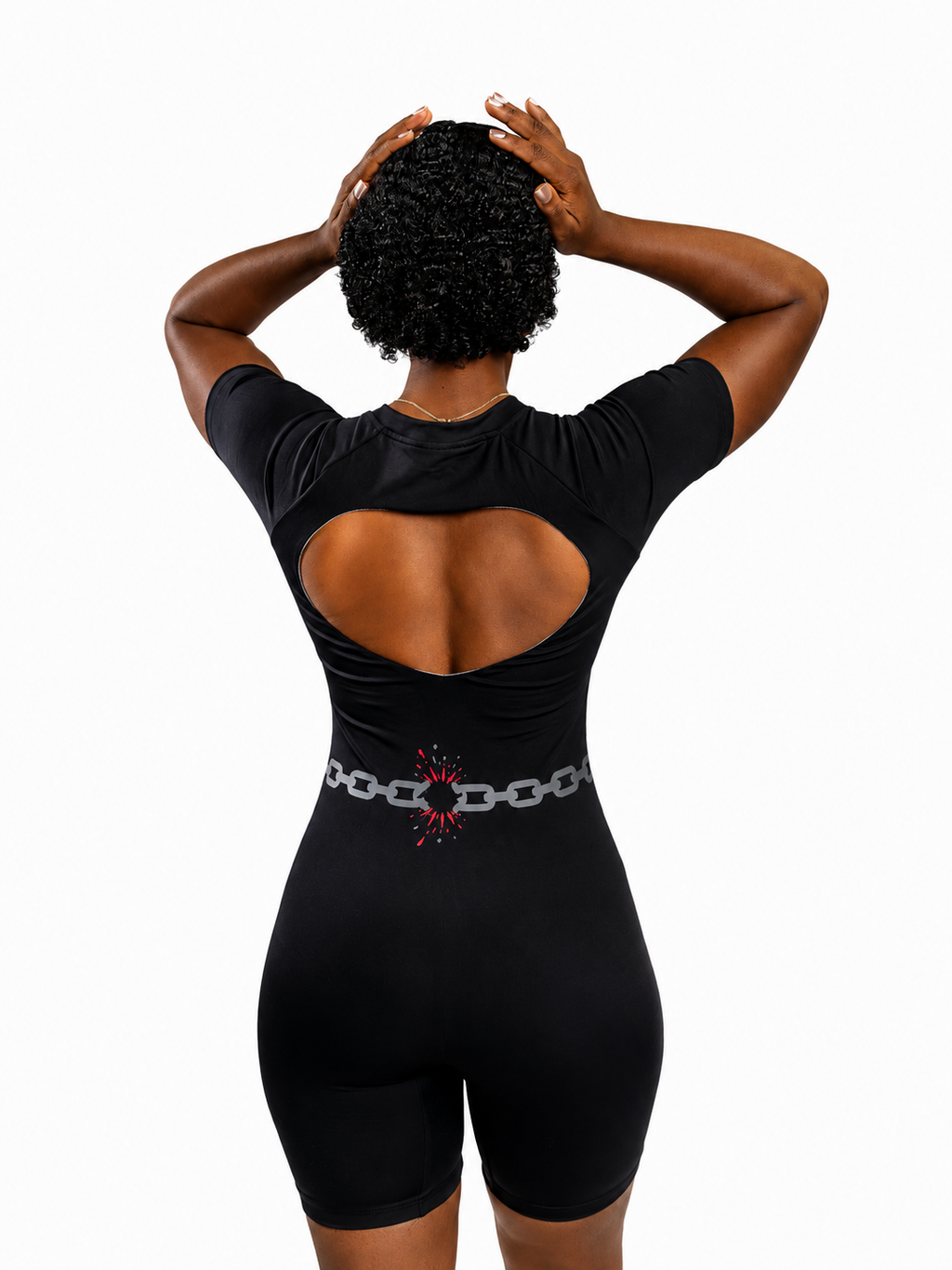 MÒN The Break Through Romper in black, back view with signature broken-chain graphic
