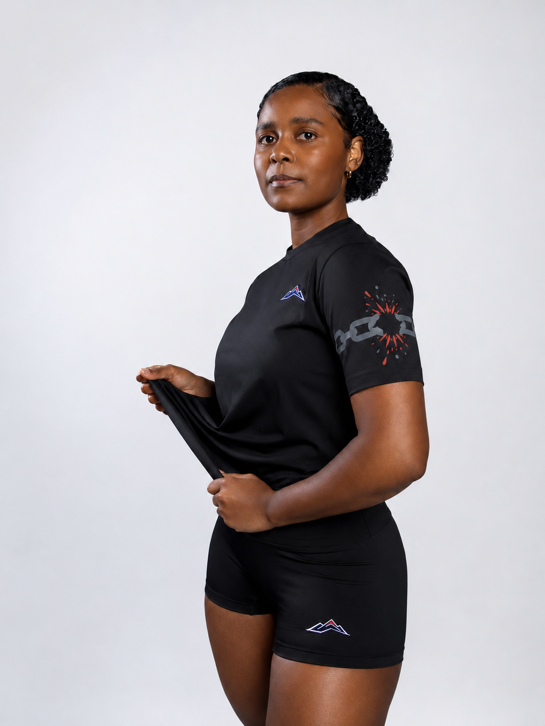 MÒN The Cost Tee in black, front view with broken-chain sleeve graphic